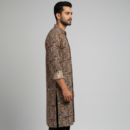 Man wearing a patterned kurta with black pants on a gray background