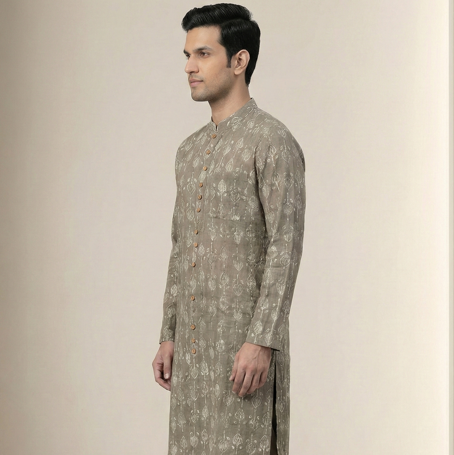 Man wearing a traditional kurta with a neutral background